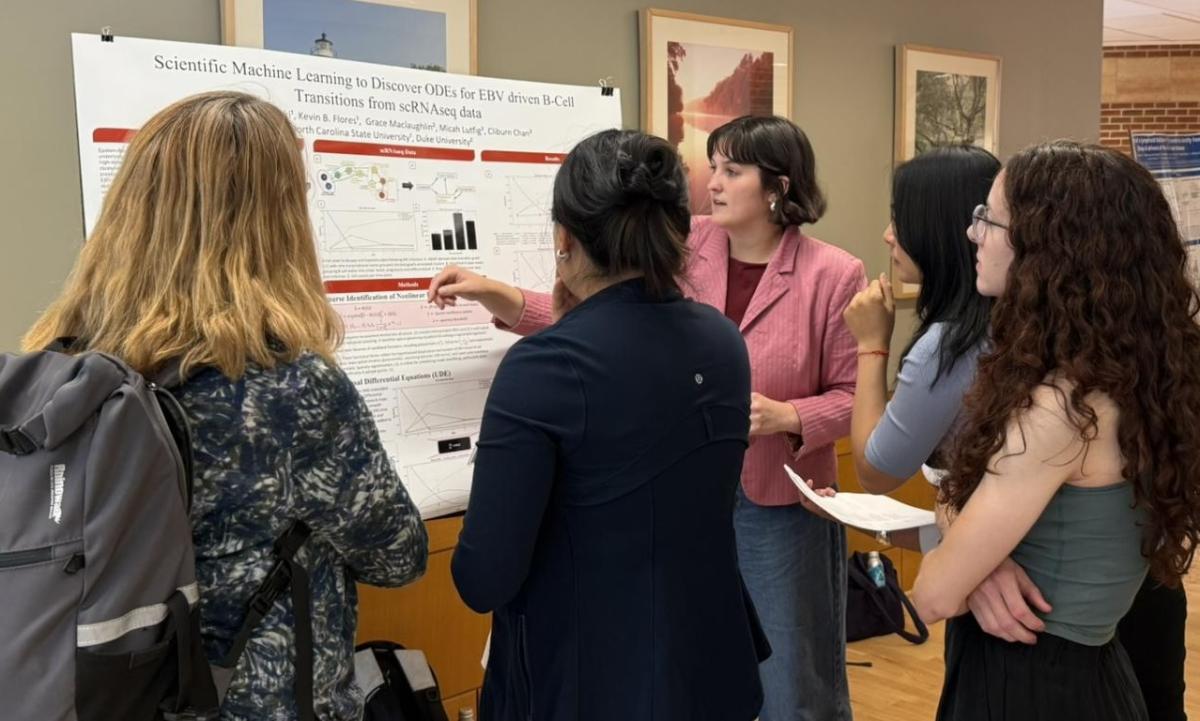 Group of scientist discussing a scientific poster at 2026 MISM & CHSI retreat